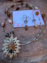 Load image into Gallery viewer, Agate Pendant flower necklace in natural colors of brown and green, hanging at 36” with Earrings.