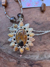 Load image into Gallery viewer, Agate Pendant flower necklace in natural colors of brown and green, hanging at 36” with Earrings.