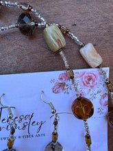 Load image into Gallery viewer, Agate Pendant flower necklace in natural colors of brown and green, hanging at 36” with Earrings.