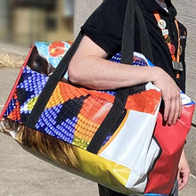 Load image into Gallery viewer, Person carrying vinyl duffle bag with webbed handles