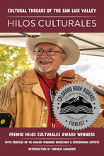 Load image into Gallery viewer, Hilos Culturales book cover with picture of smiling man wearing a cowboy hat and holding a fiddle. Colorado Book Awards sticker on front