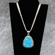 Load image into Gallery viewer, Turquoise pendant hanging on a six strand and sterling silver necklace
