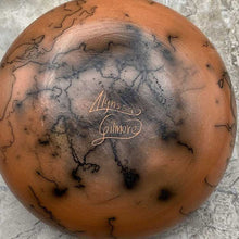 Load image into Gallery viewer, Bottom of round horsehair vase with etched designs showing artist signature.