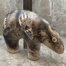 Acoma horsehair bear figurine with traditional Acoma etchings and ruler showing 6" height.