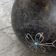 Close up of horsehair wedding vase with hummingbird etched design and turquoise stone.
