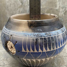 Hand etched pottery with dream catcher inlay.