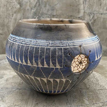 Hand etched pottery with dream catcher inlay.