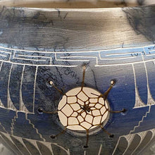 Hand etched pottery with dream catcher inlay.