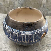 Hand etched pottery with dream catcher inlay.