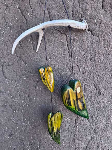 Deer antler mobile with three original painted wood hearts.  
