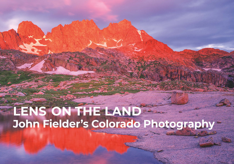 Book cover with rocky mountains and lake in forground, lit by the sunrise.
