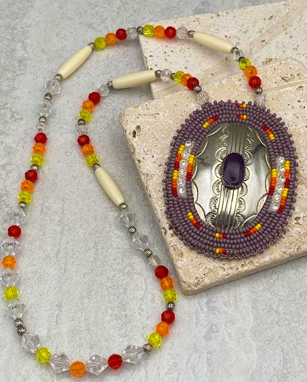 Ute beaded necklace with sterling silver plate with hand etched designs and a purple agate cabochon medallion.