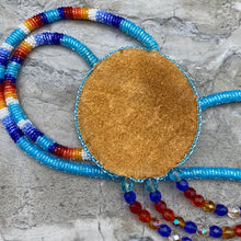 Load image into Gallery viewer, Beaded necklace showing leather backing.
