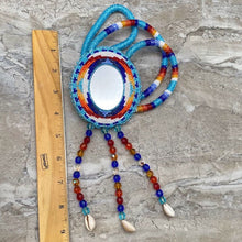 Load image into Gallery viewer, Beaded necklace with mirror center next to ruler
