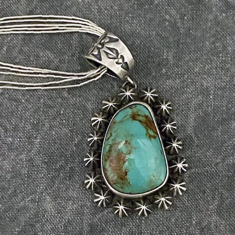 Sterling silver and turquoise necklace with star boarder and five-strand sliver necklace.