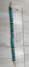 Load image into Gallery viewer, Kingman turquoise and hand-hammered bench bead bracelet and ruler showing length of 7.75&quot;.
