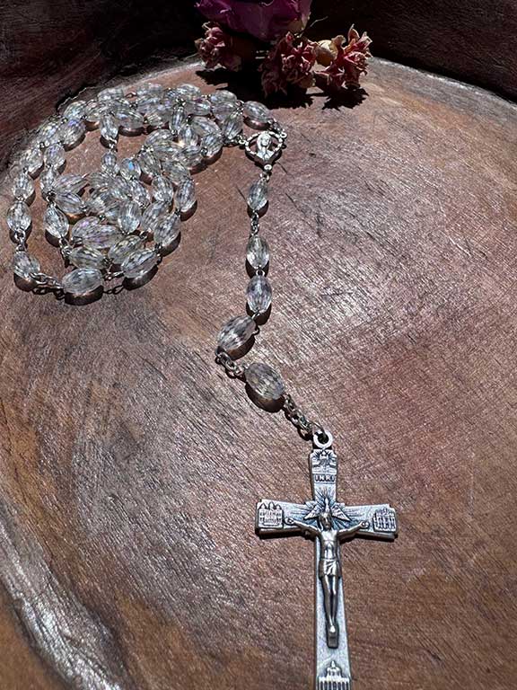 Traditional Five Decade rosary with Czech Clear crystal beads. 28” long with silvertone cross and center medal.