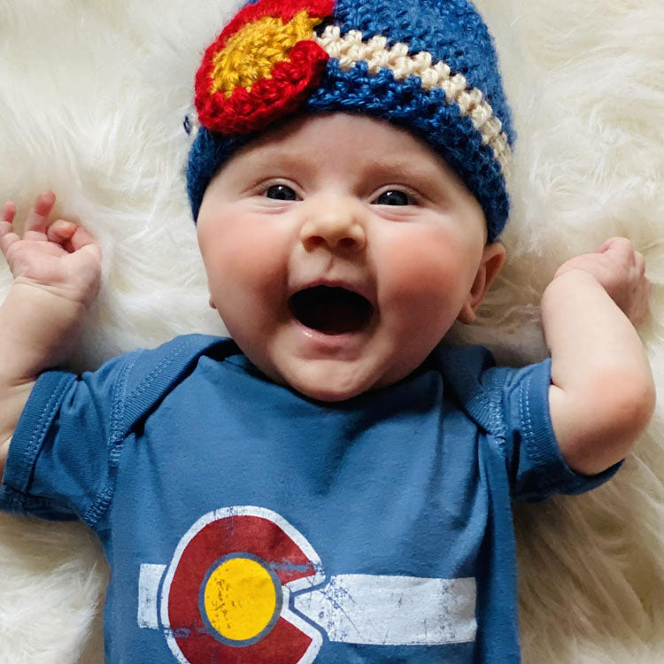 Baby with Colorado corchet beanie and Colorado flag onsie