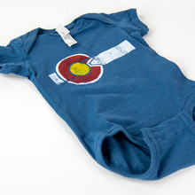 Load image into Gallery viewer, The Colorado Flag One Piece Baby Onesie is blue in color and made by local brand Yo Colorado for the History Colorado Shop.
